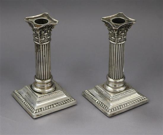A pair of late Victorian silver corinthian column dwarf candlesticks (no sconces), Sheffield, 1897, 14cm.
